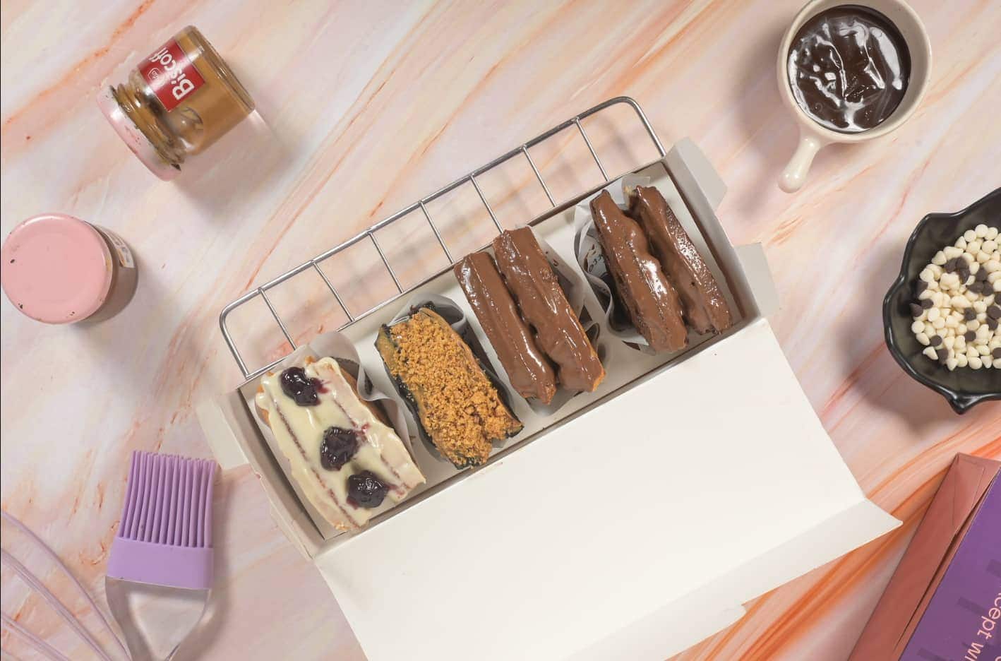 A box of four mini waff-wiches: blueberry white chocolate, Biscoff and two chocolate-dipped